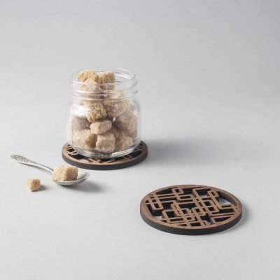 Walnut "plumber's nightmare" drinks coasters, geometric